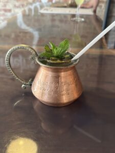 Refreshing summer cocktail with a burst of mint and lime - Classic Mojito in a cupper special made in turkey cup filled with ice, featuring white rum, gin fresh lime juice, soda water, and muddled mint leaves. Garnished with a lime wheel and sprig of mint. A cool and invigorating drink that's perfect for warm weather relaxation